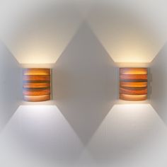 two wall lights are shown against a white wall