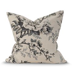 a black and white pillow with flowers on it