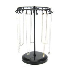 a jewelry stand with multiple chains hanging from it's sides on a white background