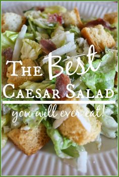 the best caesar salad you'll ever eat on a white plate with green border