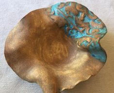 a brown and blue bowl sitting on top of a white table