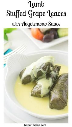 stuffed grape leaves with alfredo sauce on a white plate