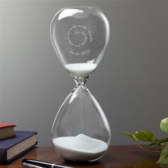 an hourglass with the words our love is tumbleless and jack in it on a desk next to a pen