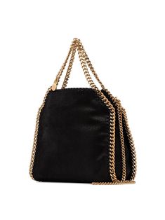 Didn't you know that a lady's outfit is never complete without a trusty bag by your side? Don't leave your house without this glamorous black faux leather black mini Falabella tote from Stella McCartney that has elegant a gold-tone chain trim adorning the front. The perfect companion to carry you throughout the day. Featuring top handles, an optional chain strap, an engraved logo charm, and a snap fastening. POSITIVELY CONSCIOUS: We’ve joined forces with ethical agency Good On You to give you th Stella Mc, Stella Mccartney Falabella, Stella Mccartney Bag, Mini Tote Bag, Don't Leave, Leather Cap, By Your Side, Crossbody Tote, Mini Tote