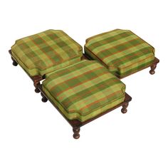 two green plaid ottomans sitting on top of each other