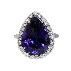 A Breathtakingly Striking HANDMADE 14k White Gold Ring with Beautiful Pear Cut Tanzanite in Bluish Violet color! The GEM is 9.29CT and measures 15.95x11.72x8.11 mm! This Stone will take your breath away, especially on the sunlight! You will want to look at this stone endlessly. The mounting is a masterpiece! HANDMADE 14K White Gold Diamond Mounting (tested), that was is custom made to Accommodate this Beauty of a Gem in a V-prongs setting! Super FINE Workmanship on the Diamond v-split setting with 24 pcs Brilliant Full Cut Diamonds in G color, SI1 clarity, totaling to approx 0.64 ct! Fabulous Braided Band and Diamond Gallery! The Entire Top's outline is 20.0x15.0 mm- HUGE. The Ring weights 7.6 g, nice and SOLID. Sits 8.0 mm off the top of the finger. Finger size 7 (Free Re-sizing with purc Elegant Pear-shaped Gemstones For Formal Occasions, Elegant Pear-shaped Gemstones For Anniversary, Classic Pear-shaped Gemstones For Anniversary, Formal Pear-shaped Jewelry With Halo Setting, Tanzanite Diamond, Violet Color, No Heat, 14k White Gold Ring, Stone Cuts