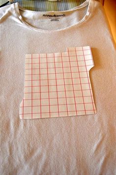 a t - shirt with a piece of paper taped to the front and back of it