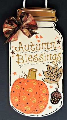 an autumn sign hanging from the side of a wall