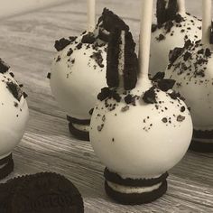 oreo cake pops with white frosting and chocolate sprinkles on them