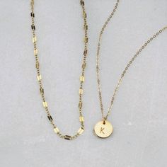 Two of our best selling necklaces in one set! Choose gold filled or sterling silver. Perfect for your everyday tee shirts, makes a wonderful gift too. -Set of two necklaces -Top Layer is a chain style in your choice -Bottom Layer Disc Necklace -Petite disc measures 10mm -Choose 14kt Gold-Filled or Sterling Silver -A high quality delicate link chain. -Polished to a light satin finish. CUSTOM HAND STAMPING -Hand stamped in classic block font with an initial. -Your choice of text up to 3 letters on Minimalist Gold-plated Sterling Silver Chain Necklace, Gold Dainty Charm Necklace For Everyday, Dainty Gold Charm Necklace For Everyday, Everyday Gold Round Chain Necklace, Gold Round Chain Necklace For Everyday, Everyday 14k Gold Filled Chain Necklace With Round Pendant, Gold Round Necklace For Everyday Wear, Silver 14k Gold Filled Charm Necklaces For Everyday, Gold Adjustable Round Disc Charm Necklaces