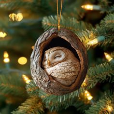 an owl ornament hanging from a christmas tree