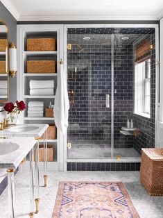 a bathroom with gray tile and gold accents