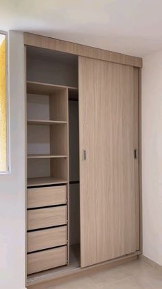 an empty room with a large wooden closet