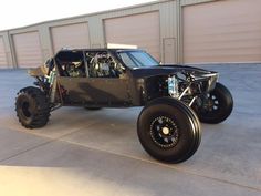 an off - road vehicle parked in front of a garage