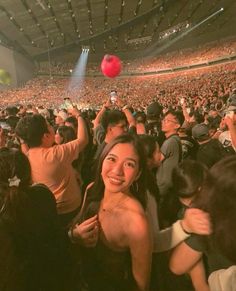 a woman standing in front of a crowd at a concert