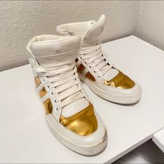 Gold And White Gucci High Top Sneakers Size 7 But Fits As Well A Size 8 Modern Gold High-top Sneakers, Gucci White Sporty High-top Sneakers, Gucci White High-top Sneakers Sporty Style, Sporty Gucci White High-top Sneakers, White Sporty Gucci High-top Sneakers, Designer Gold Lace-up Sneakers, Gucci High-top Sneakers, Designer Gold Low-top Custom Sneakers, Designer Gold Custom Low-top Sneakers