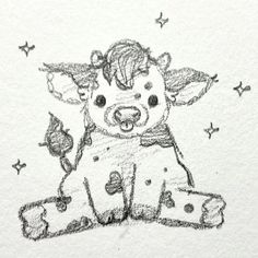 a drawing of a cow sitting on top of a piece of paper with stars around it