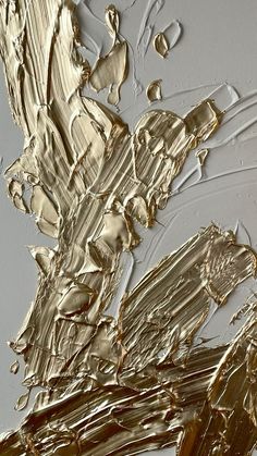 an abstract painting with gold and silver paint