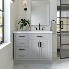 a bathroom with a large mirror and double sink vanity in front of a sliding glass door