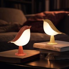 two lamps sitting on top of a table next to each other