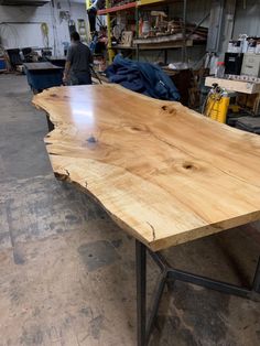 a large wooden table with metal legs in a shop