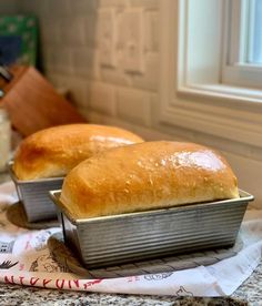 two loafs of bread sitting on top of a counter