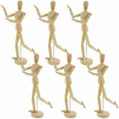 six wooden mannequins with different poses holding plates