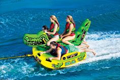 Two woman riding in a WOW Watersports Big Al Towable Tubes - 4 Person - Green and yellow - looks like an Alligator - Heavy-duty full nylon cover with heavy-duty zippers with two secure saddle seats and – Double webbing foam handles with EVA foam knuckle guards. Two man beside the two woman on lake Hydrotherapy Pool, Later Alligator, See You Later Alligator, Summer Boats, Big Al, Inflatable Water Park, Body Padding