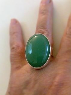 "The Aventurine gem is a beautiful green, is oval, cabochon 30 x 22.The ring band is 8 mm width.it is made with solid silver 925. *This jewel will be sent to you in a beautiful gift box * All the pieces are Hand Made * Custom order We will be glad to make any size, style, other gemstone or any other variation that you prefer. Usually it takes 1- 3 days. Reviews: \"Thank you very much! So pretty.\" \"Thank you for the beautiful ring, I love it!\"" Modern Green Oval Cabochon Jewelry, Green Rings With Large Oval Cabochon Stone, Green Oval Ring With Large Stone, Green Oval Rings With Large Stone, Oval Green Ring With Large Stone, Green Oval Cabochon Ring With Large Stone, Handmade Green Emerald Oval Cabochon Ring, Aventurine Ring, Aventurine Stone