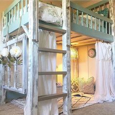 the bunk bed is made out of wood and has curtains hanging from it's sides