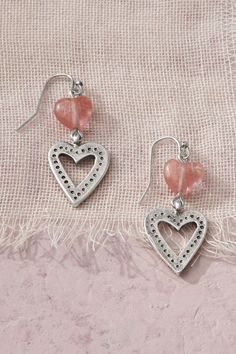 These winsome earrings pair a sculpted pink quartz bead with an etched cutout charm – for a double dangle of hearts. Pierced Dangle Heart Earrings For Mother's Day, Mother's Day Heart Beads Dangle Jewelry, Nickel Free Dangle Heart Earrings, Pink Metal Pierced Jewelry, Pink Double Heart Pierced Earrings, Pink Double Heart Pierced Jewelry, Heart Beads Metal Drop Earrings, Pink Double Heart Jewelry With Matching Earrings, Metal Heart Beads Drop Earrings