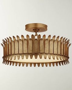 a chandelier that is made out of wood and has spikes on the bottom