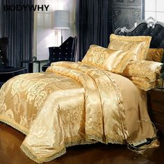 a bed with gold comforter and pillows in a room