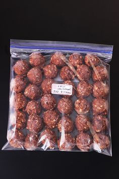 a plastic bag filled with chocolate balls on top of a table