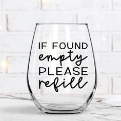 a wine glass with the words if found empty please relie written in black on it