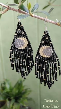 black beaded earrings hanging from a tree branch