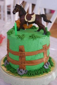 a green cake with a horse on top