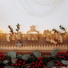 a wooden nativity scene with christmas decorations