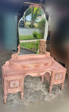 an antique pink dressing table with mirror on top