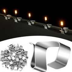 there are many candles that are lit up in the dark night, along with some silver objects