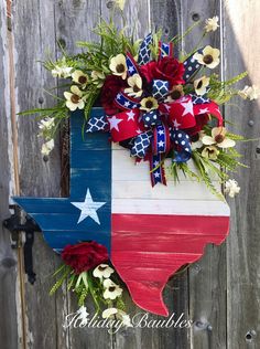 a wooden texas flag wreath with red, white and blue flowers