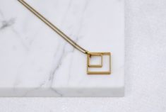 Two Squares Pendant | Minimal Geometric Jewelry | Everyday Necklace Minimalist Brass Necklace With Rectangular Pendant, Minimalist Brass Square Pendant Jewelry, Minimalist Brass Necklace With Square Pendant, Minimalist Rectangular Brass Jewelry, Raw Peridot, Geometric Pendant Necklace, Shrink Film, Round Bead Necklace, Chevron Necklace