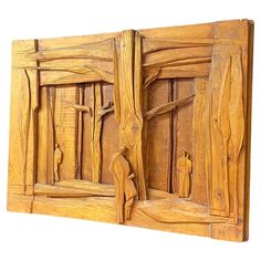 a wooden panel with carvings on it