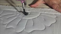 someone is using a sewing machine to stitch a quilt