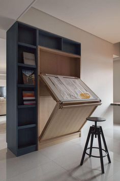 an open book shelf in the middle of a room with stools and bookshelves