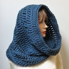 a mannequin wearing a blue knitted cowl with a hood on it's head