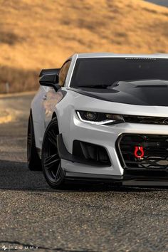 the chevrolet camaro is driving down the road