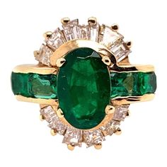 Retro 14k Yellow Gold Cocktail Ringset with approximately 3.10 Carats of Natural Diamonds & Oval Green Emerald. The center oval measurements are 9.1x5.95x3.5 and weighs approximately 1.50 carats. The four sidestone natural emeralds weigh approximately 0.70 carats. The 12 natural baguettes are approximately G-I in color and VS-SI in clarity and weigh 0.93 carats. The ring weighs 5.8 grams and is a size 6. Circa 1950. Condition is Pre-owned. Oval Yellow Gold Emerald Ring With Multi-stone, Oval Yellow Gold Emerald Ring With Multiple Stones, Gia Certified Oval Collectible Ring, Green Oval Diamond Ring Collectible, Classic Oval Multi-stone Cluster Ring, Classic Oval Emerald Ring Stamped 14k, Classic Oval Cluster Ring With Multi-stone, Oval Diamond Cluster Ring Collectible, Vintage Oval Gia Certified Cluster Ring