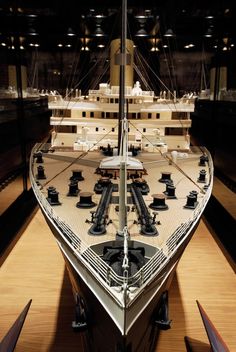 a large model ship is on display in a museum