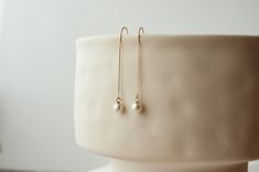 "Introducing these exquisite 14K real gold natural pearl threader earrings, the perfect bridal accessory for your special day. Handcrafted with love, these earrings feature a delicate 14K box chain and natural freshwater pearls. The drop length of these earrings measures 2 inches from the earlobe to the pearl, creating an elegant and elongating effect. Unlike plated or gold-filled options, these earrings are made with real 14K solid gold, ensuring lasting beauty and quality. Elevate your bridal 14k Yellow Gold Linear Earrings For Wedding, Minimalist Pearl Earrings For Wedding With Ear Wire, Minimalist Round Linear Earrings For Wedding, Minimalist Linear Earrings For Wedding, 14k Gold Linear Earrings For Wedding, 14k Gold Round Linear Earrings For Wedding, 14k Gold Filled Long Drop Pearl Earrings For Wedding, White Threader Earrings For Wedding, 14k Gold Minimalist Linear Earrings For Wedding